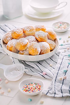 Cottage cheese donuts balls with sugar in a bowl. Healthy curd dessert