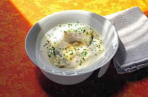 Cottage cheese dumplings in whey soup with chives on top