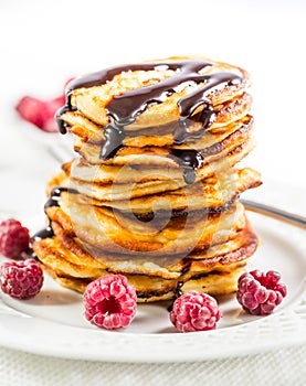 Cottage cheese pancakes with fresh raspberry and chocolate sirup