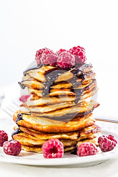 Cottage cheese pancakes with fresh raspberry and chocolate sirup