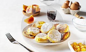 Cottage cheese pancakes with ingredients: gluten free flour, maple syrup, oranges' peels, eggs