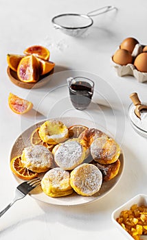 Cottage cheese pancakes with ingredients: gluten free flour, maple syrup, oranges' peels, eggs