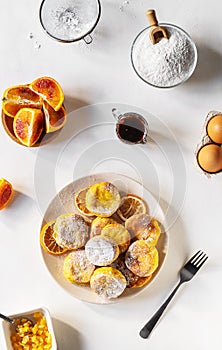 Cottage cheese pancakes with ingredients: gluten free flour, maple syrup, oranges' peels, eggs