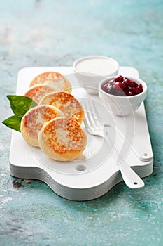 Cottage cheese pancakes Russian syrniki with cranberry jam and yogurt