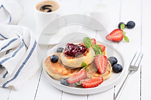 Cottage cheese pancakes or Syrniki with berries, jam