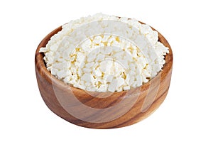 Cottage cheese in rustic wooden bowl, isolated on white.