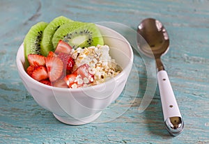 Cottage cheese with strawberries, kiwi, honey, cereals and seeds of flax - a healthy food, tasty and healthy Breakfast or snack
