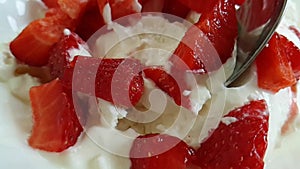 Cottage cheese in a strawberry spoon slow motion