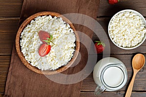 Cottage cheese with strawberry in wooden bowl