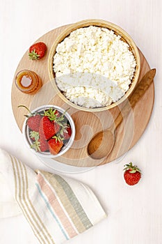 Cottage cheese with summer strawberries cherry berries.curd cheese in bowl with honey.Healthy dairy Calcium,Protein