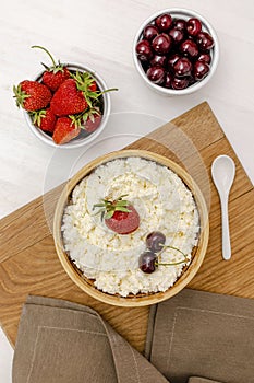 Cottage cheese with summer strawberries cherry berries.curd cheese in bowl with honey.Healthy dairy Calcium,Protein product,food