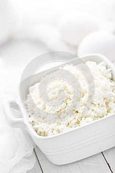 Cottage cheese on white wooden rustic background
