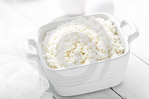 Cottage cheese on white wooden rustic background