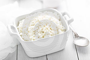 Cottage cheese on white wooden rustic background