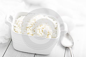 Cottage cheese on white wooden rustic background