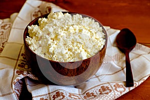 Cottage cheese in the wooden bowl