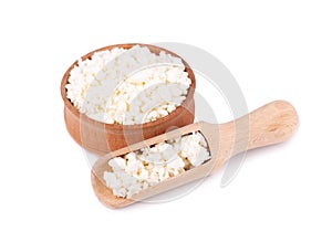 Cottage cheese in a wooden bowl isolated on a white background.