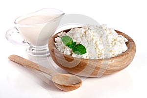 Cottage cheese in a wooden bowl isolated on a white background