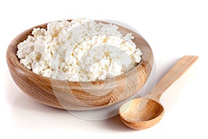 Cottage cheese in a wooden bowl isolated on a white background