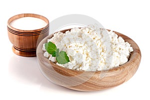 Cottage cheese in a wooden bowl isolated on a white background