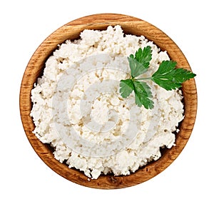 Cottage cheese in a wooden bowl isolated on a white background. Top view. Flat lay