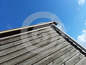 Cottage farm gutter with blue sky photo