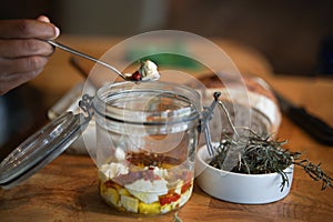 Cottage farmer paneer cheese, sun dried tomatoes and rosemary marinated in olive oil in glass jar