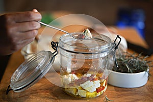 Cottage farmer paneer cheese, sun dried tomatoes and rosemary marinated in olive oil in glass jar