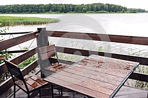 Cottage in forest near river with big wooden terrace. House on the water at the lake, a beautiful bank. Ideal place for