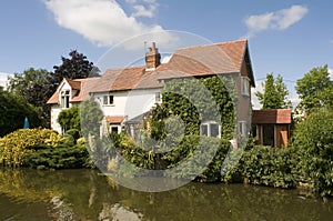 Cottage house alongside canal photo