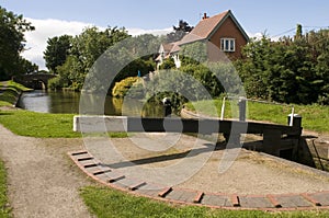 Cottage house alongside canal photo