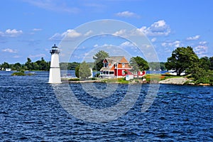 Cottage with lighthouse, Thousand Islands, New York state, USA photo
