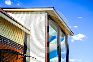 Cottage with panoramic large Windows. Glazing of the facade of the house