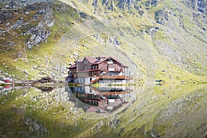 A cottage with reflection in mountain lake