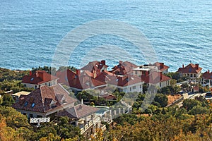 Cottage town on the hillside in the background of the sea