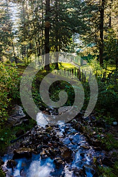 Cottage, waterfall in beautiful forest