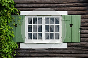 Cottage window shutters decorated with hearts. Sweden