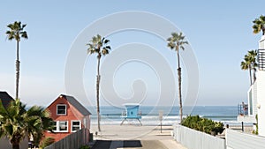 Cottages in Oceanside California USA. Beachfront bungalows. Ocean beach palm trees. Lifeguard tower. photo