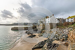 Cottages by the sea, Bamaluz Beach in St Ives, Cornwall, UK