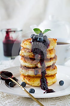 Cottege cheese pancakes Gluten-free with blueberry sauce on a light background.