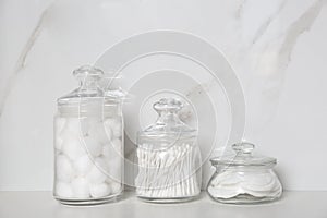 Cotton balls, swabs and pads on white table