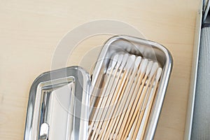 Cotton bud in stainless container on table in doctor room container for surgical