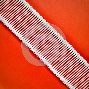 Cotton buds arranged diagonals in a row on a red background. photo