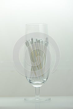 Cotton buds in a champagne glasses