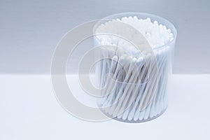 Cotton buds or cotton swabs in transparent plastic box isolated on white background