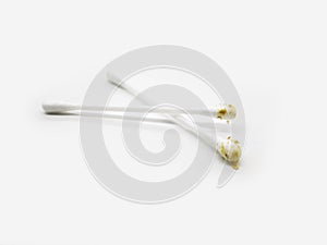 Cotton buds with Earwax and Hair in the ear isolated on white background