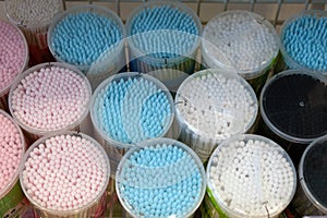 Cotton buds in plastic cylindrical boxes with lids,
