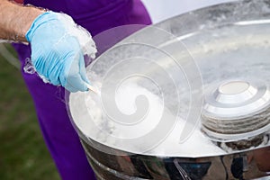 Cotton candy cooking, candyfloss machine close up on the street