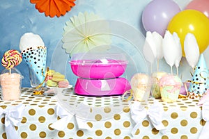 Cotton candy machine and treats on table