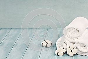 Cotton Flowers and Fresh Laundered Towels Against Blue Background